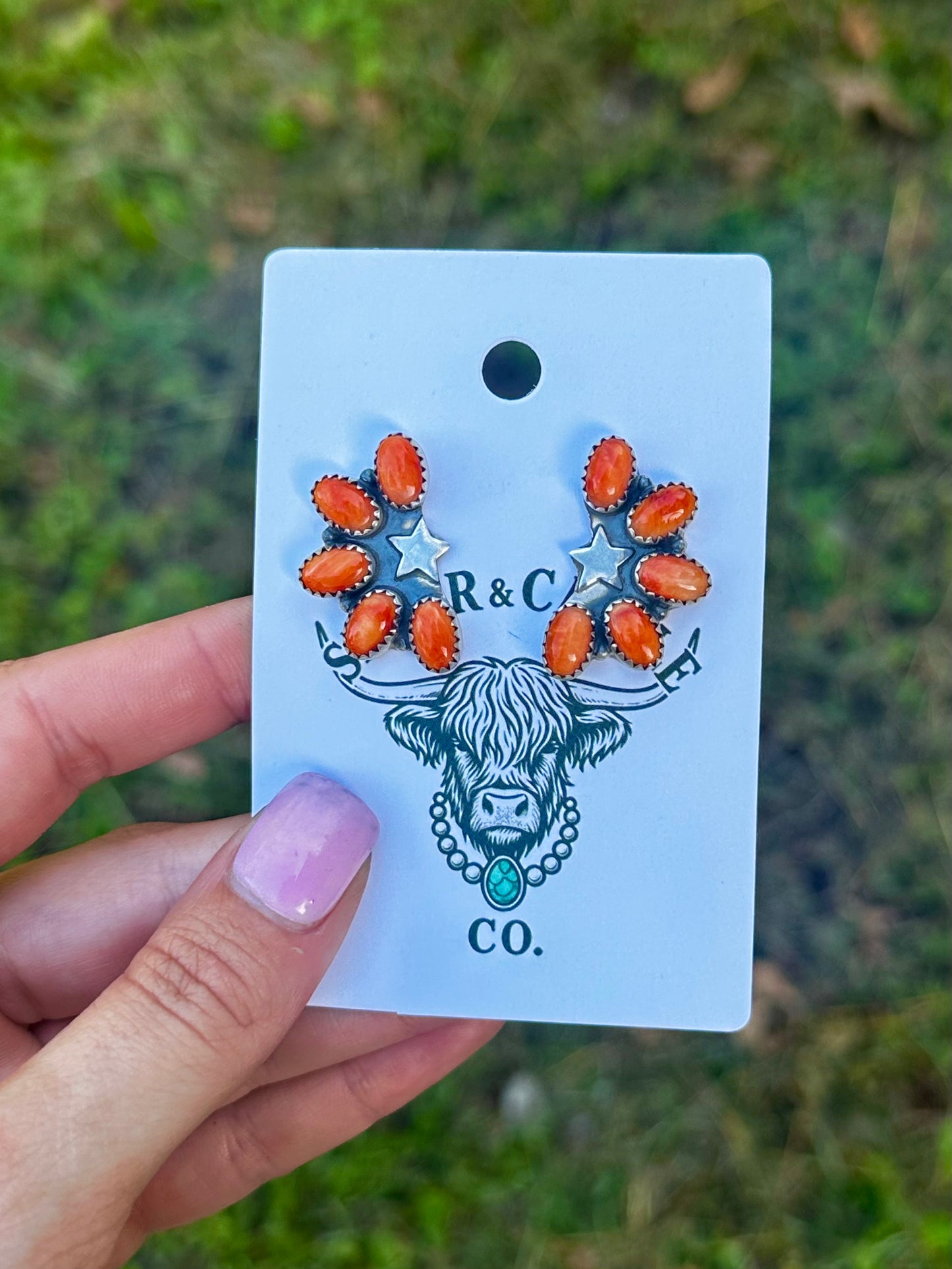 Orange spiny half cluster star earrings
